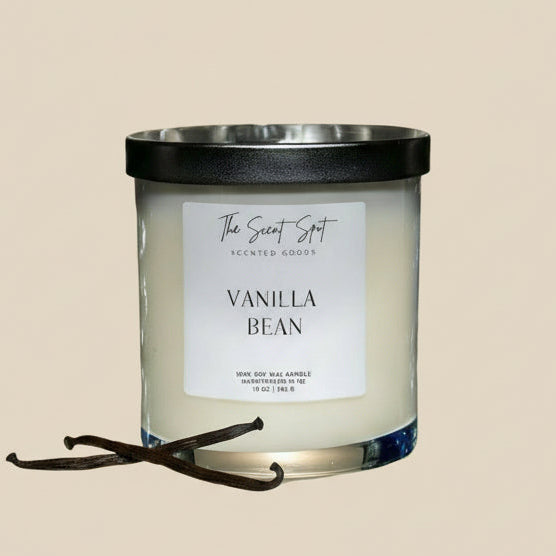 Vanilla bean scented candle with a black lid on a beige background