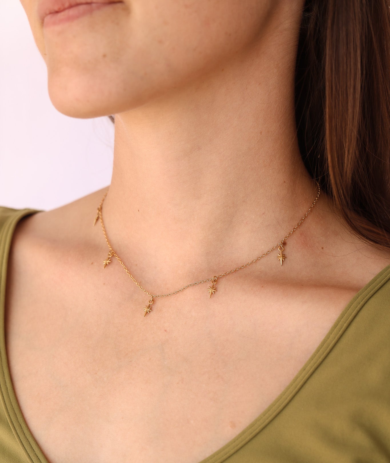 Necklace worn by a person with a plain background